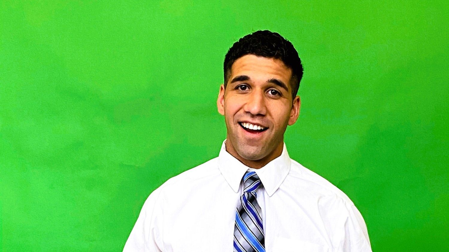 Person standing in-front of a green screen