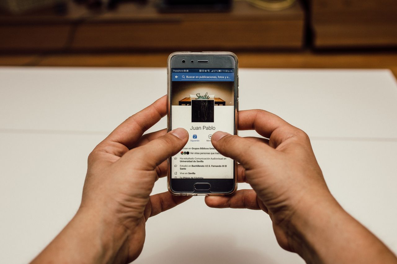 A man is browsing engaging Facebook video ads
