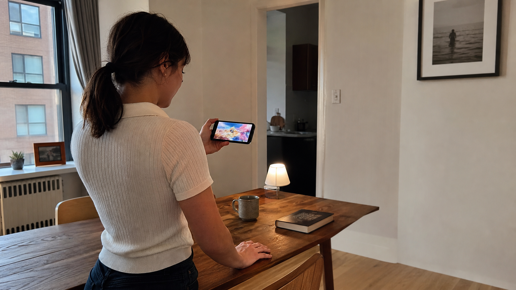 Western creator reviewing an indistinct generated video on a smartphone in a lived-in city apartment.
