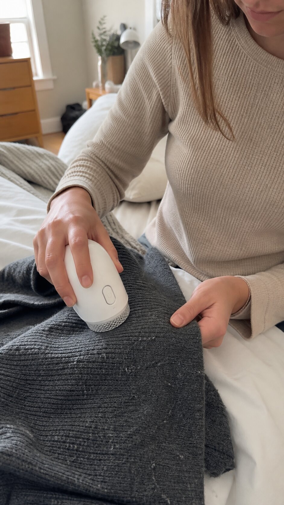 Creator uses a portable fabric shaver on a dark sweater, used as the shared UGC commerce comparison input.