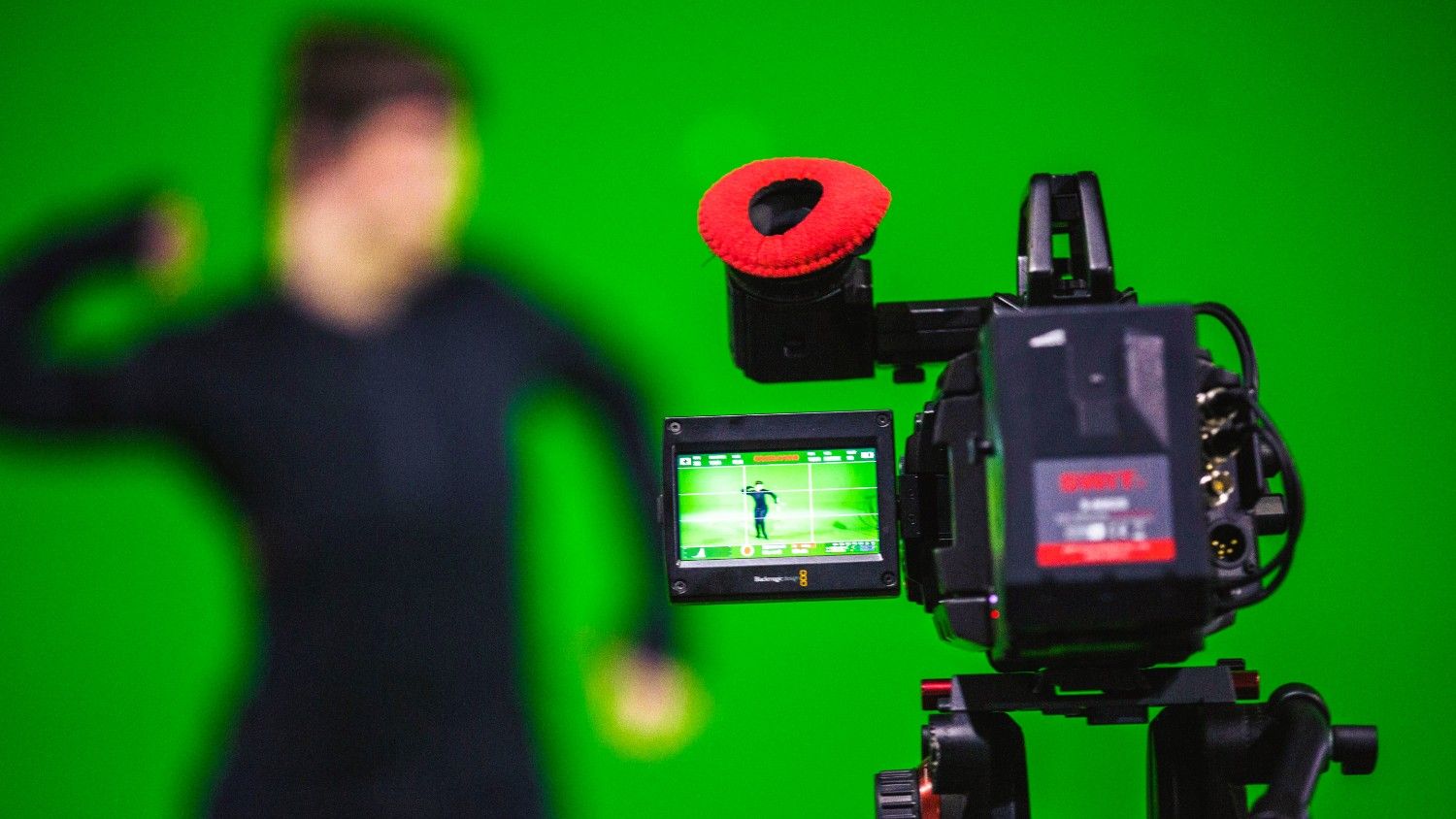 Filming infront of solid green color background